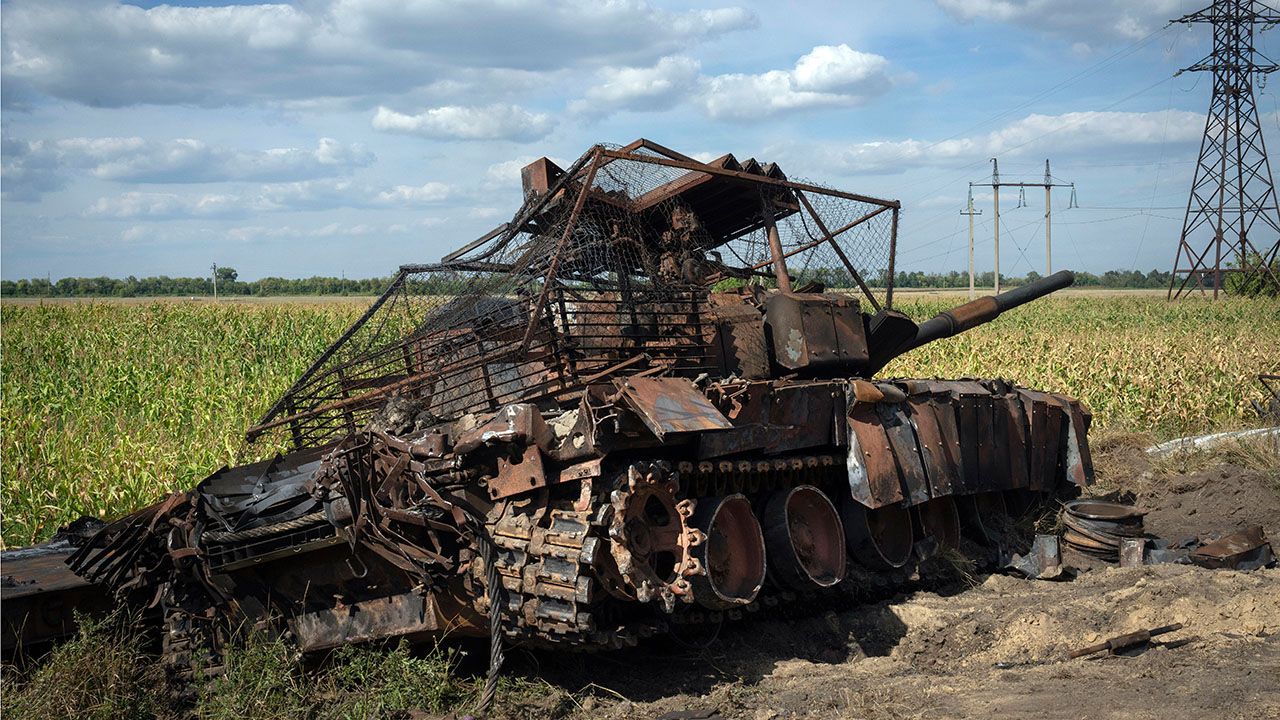 A destroyed Russian tank sits on a roadside near the town of Sudzha, Ukraine