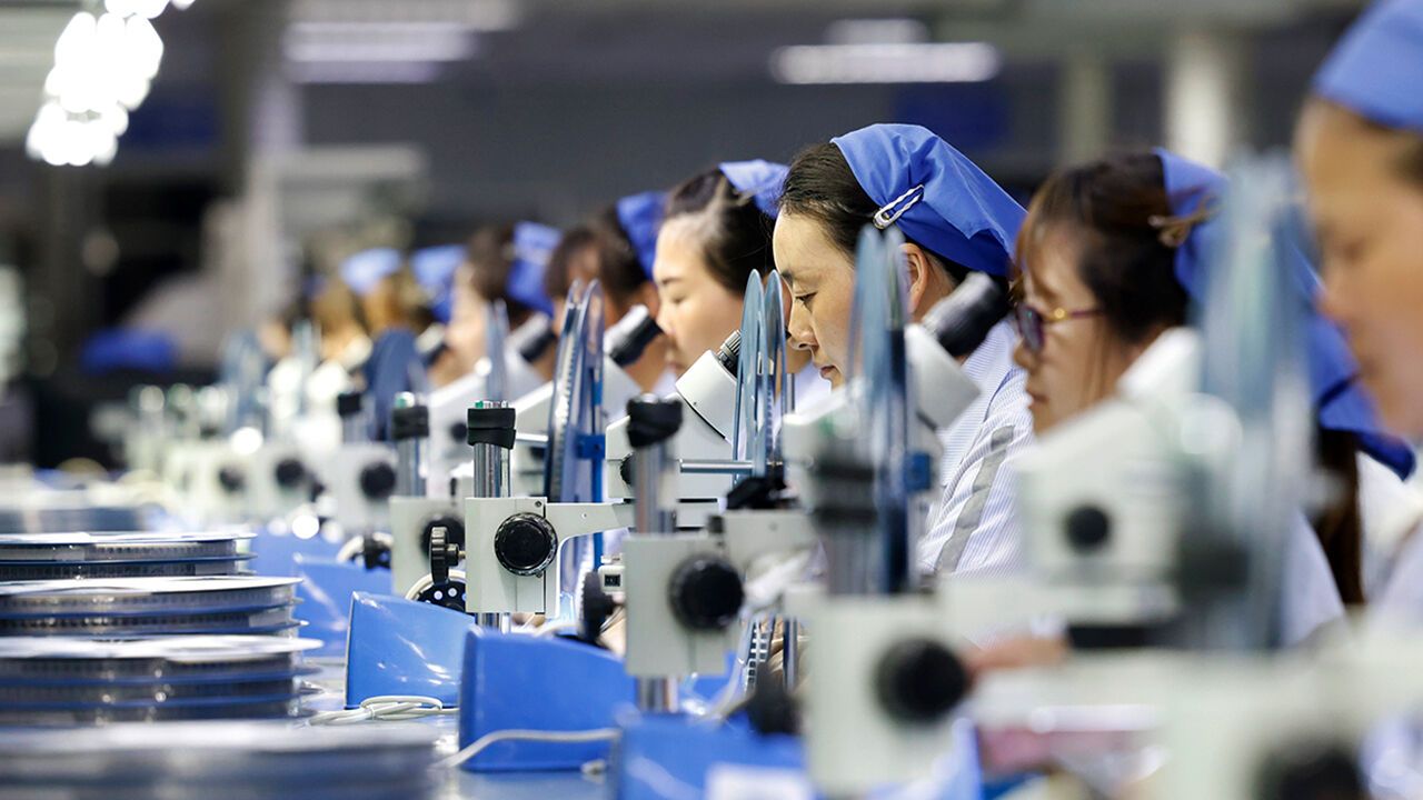 Workers are producing electronic products for export in the workshop in Suqian City, China