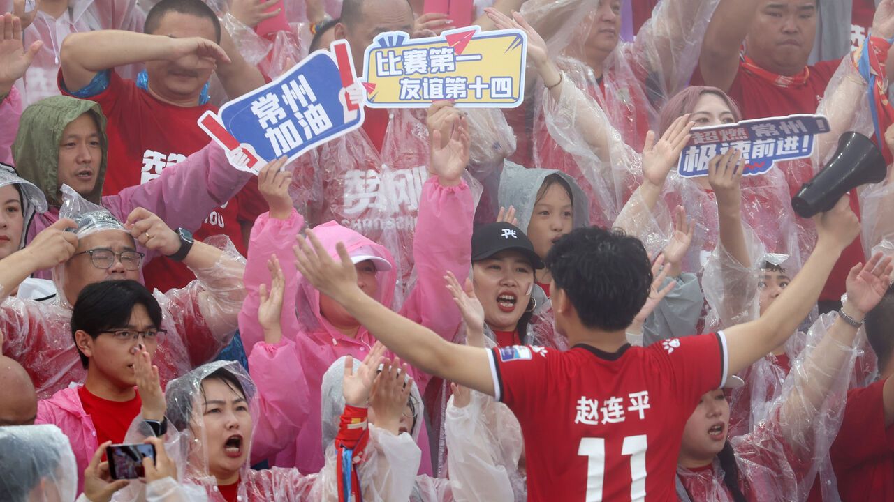 Football fans cheer for players during the 5th round match between Changzhou team and Nanjing team at the 2025 Jiangsu Football City League in Changzhou, Jiangsu Province of China.